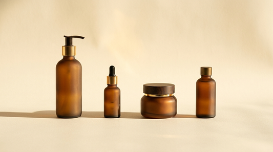 Four apothecary bottles in warm golden light on a cream backdrop, representing the SOL four-step ritual